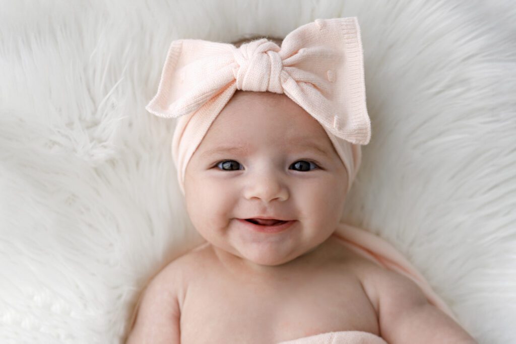 2 month old baby girl smiling
