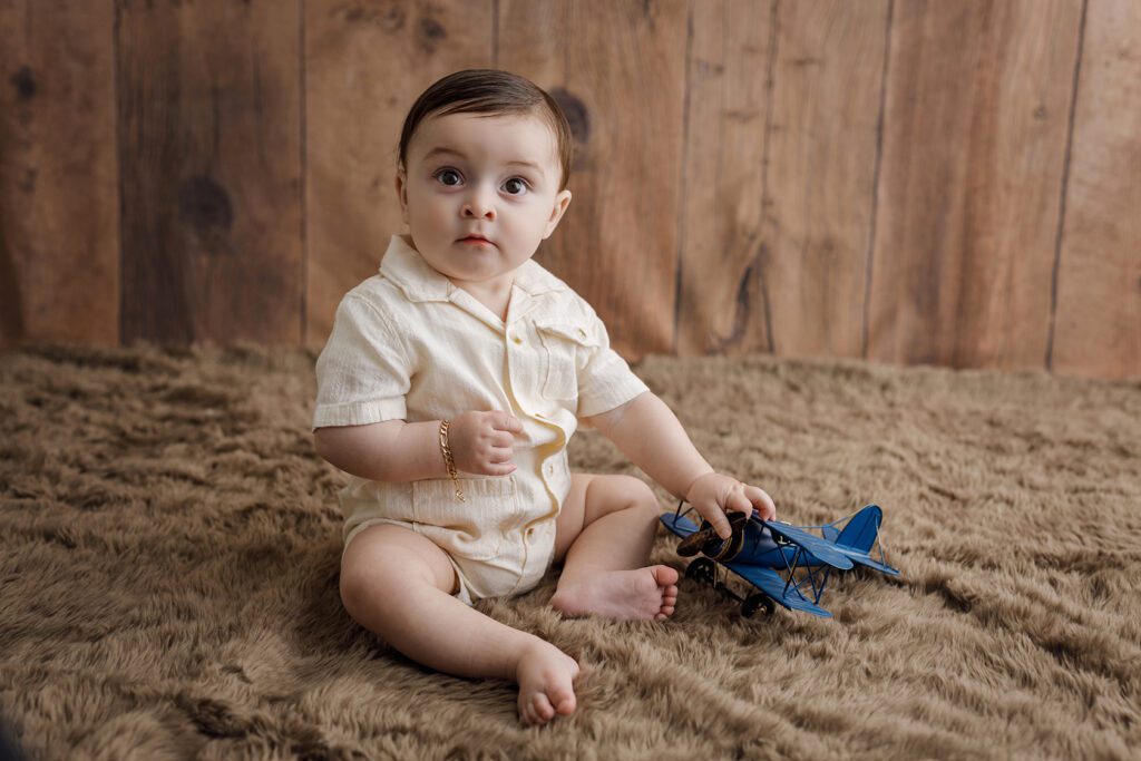 baby with airplane toy
