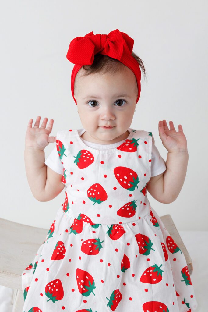 baby in strawberry dress