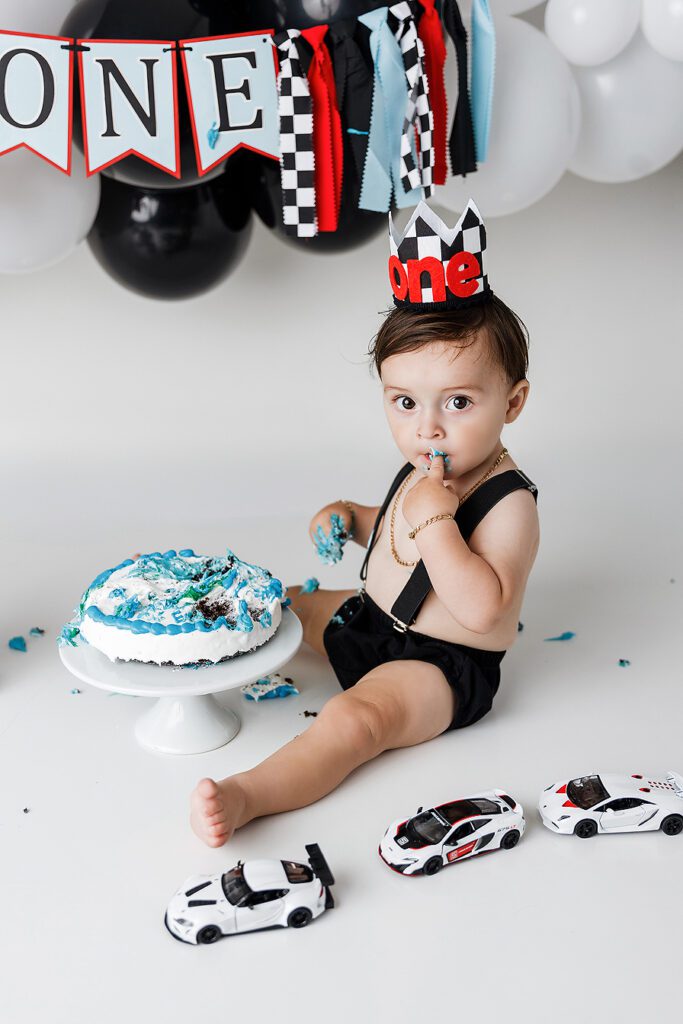 baby eating 1st birthday cake