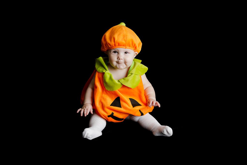 baby wearing Halloween pumpkin costume