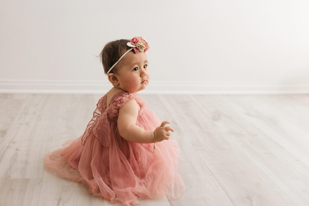 baby girl in pink dress