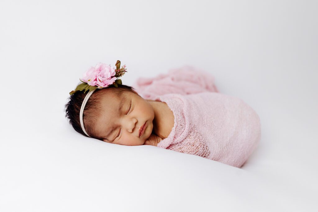 newborn baby girl in pink wrap