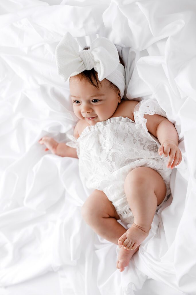 cute baby girl in white bow