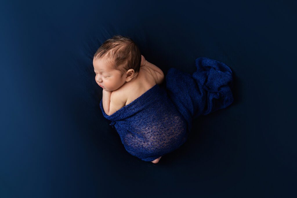 baby boy in blue swaddle
